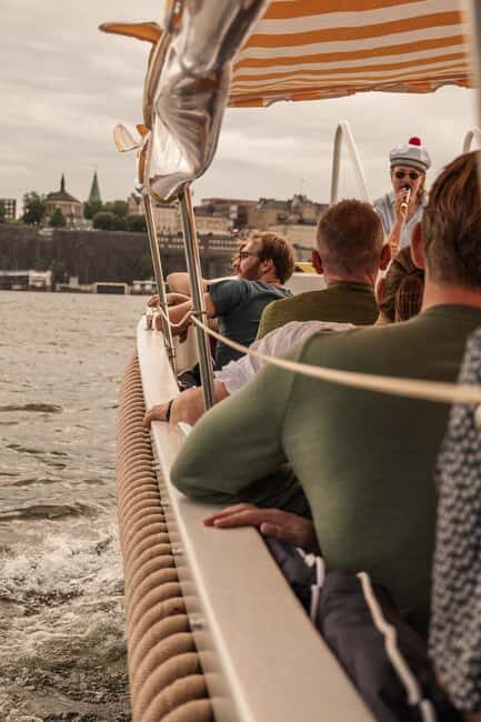 Stockholm: Guided City Sightseeing Open Electric Boat Tour - Djurgården canal, low bridges, and the Nordic Museum spires